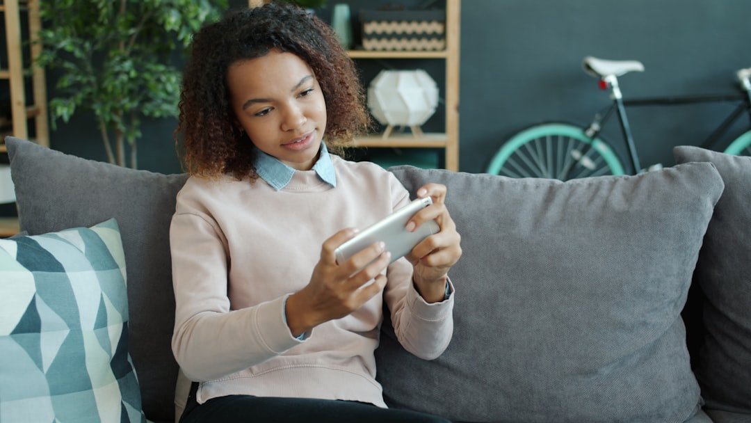 a young adult checking investments on a phone