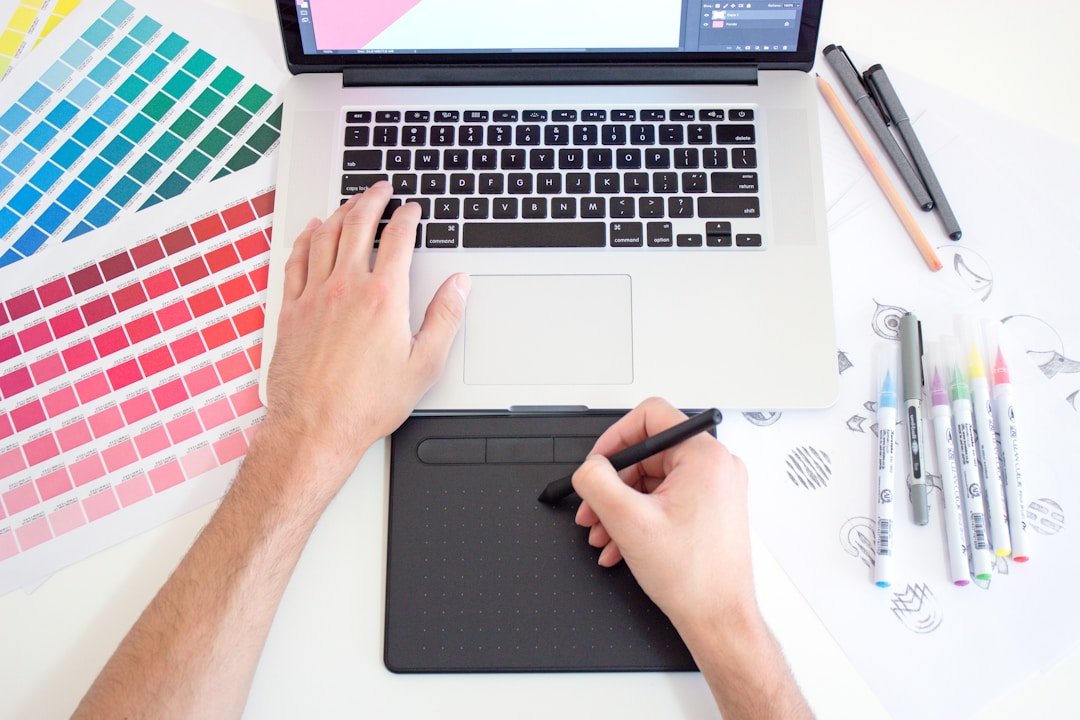 a designer refining an AI-generated presentation slide with custom brand colors and hand-drawn artwork next to a laptop