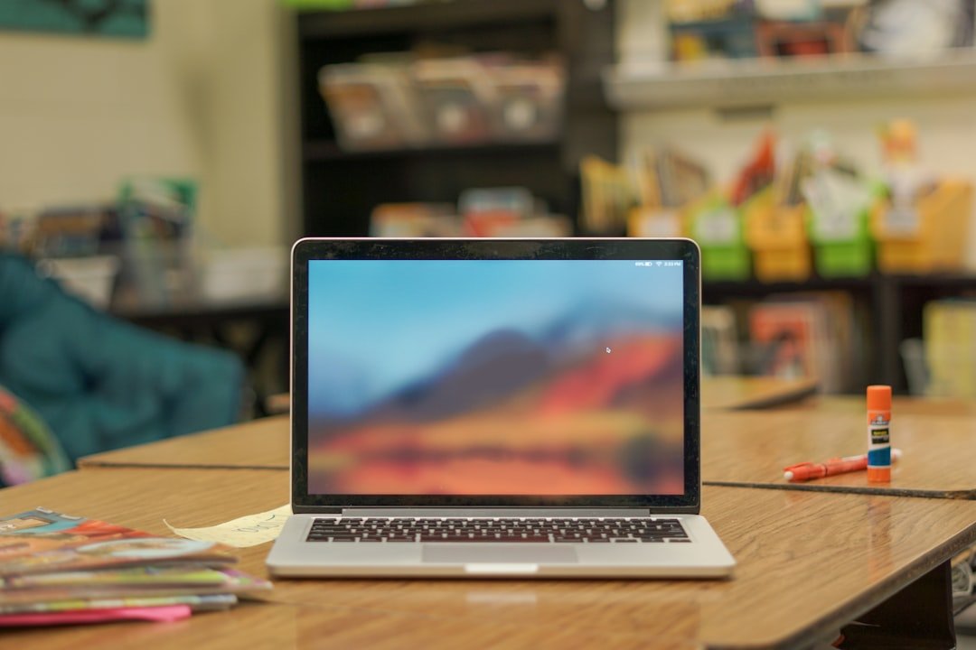a teacher planning lessons at a desk with a laptop