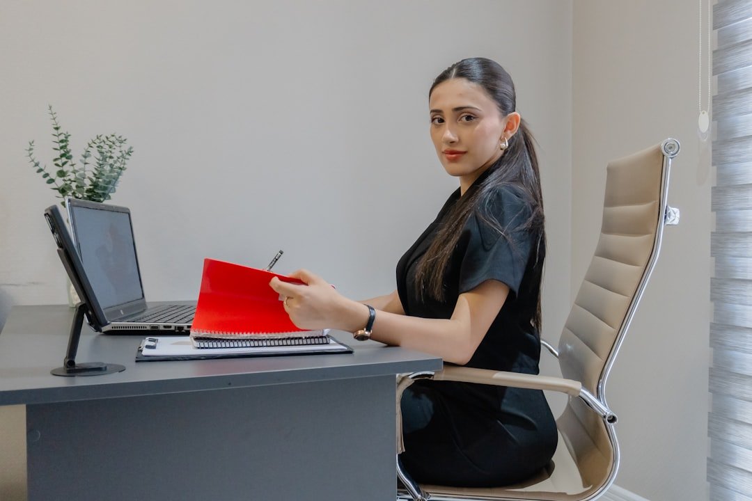 Editing a printed draft with a red pen at a desk