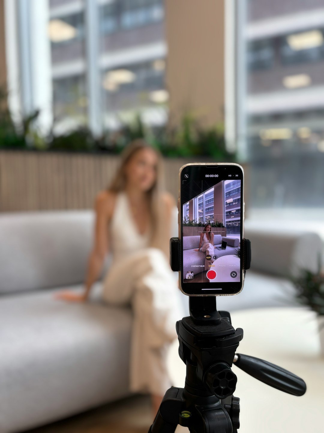 Recording a short clip on a smartphone tripod to test a free AI video generator
