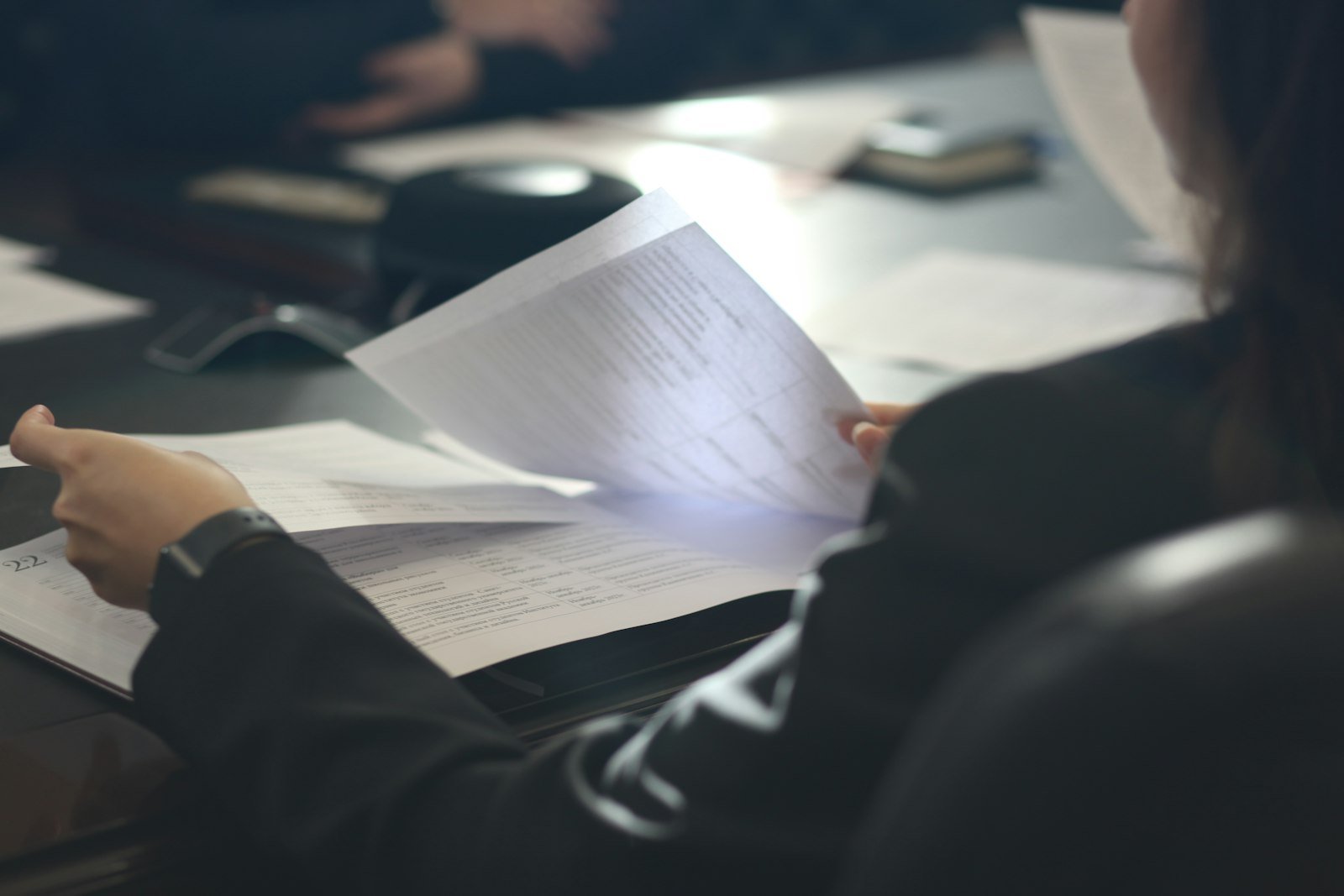 Flipping through a printed source document before uploading it as a NotebookLM source