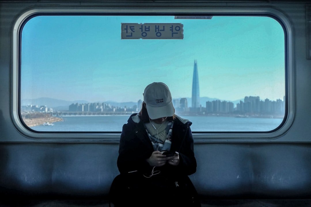 a commuter on the Seoul subway using a smartphone