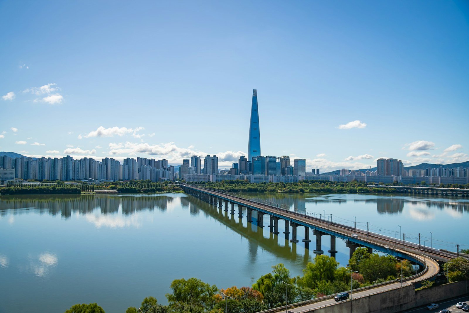a modern Seoul cityscape with a bridge over the Han river