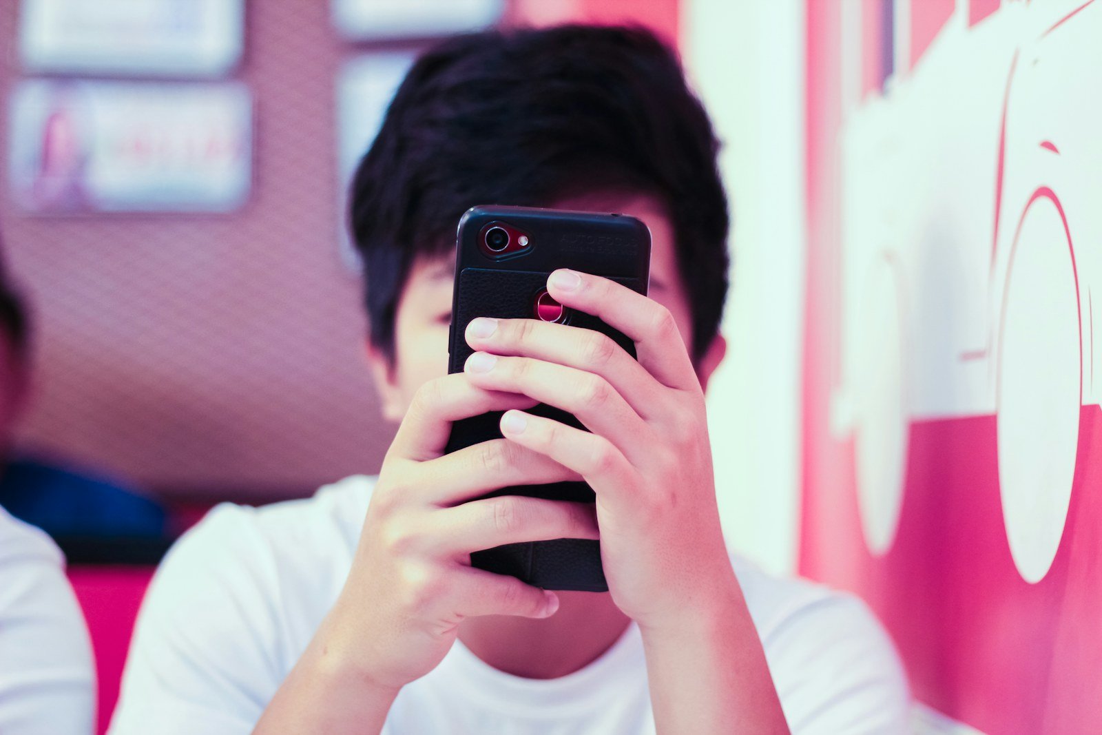 a young person absorbed in a chat app on their phone